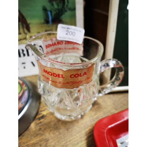 200 - Mc Keena & Mc Kinley & Co Model Cola glass water jug and Heineken tinplate ashtray.