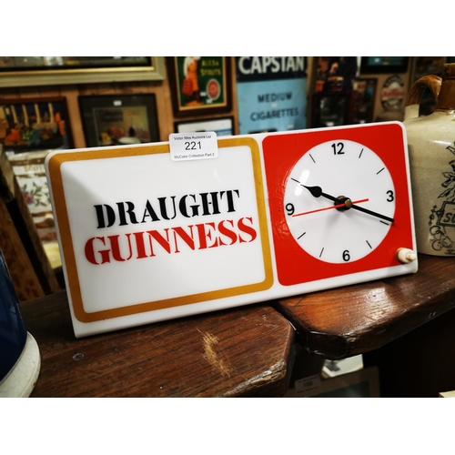 221 - Draught Guinness electric Perspex advertising clock. { 15cm H X 31cm W }.