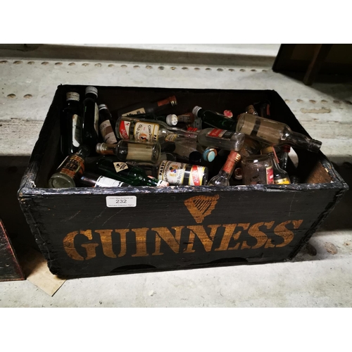 232 - Guinness wooden bottle crate with miniature bottles some with contents.