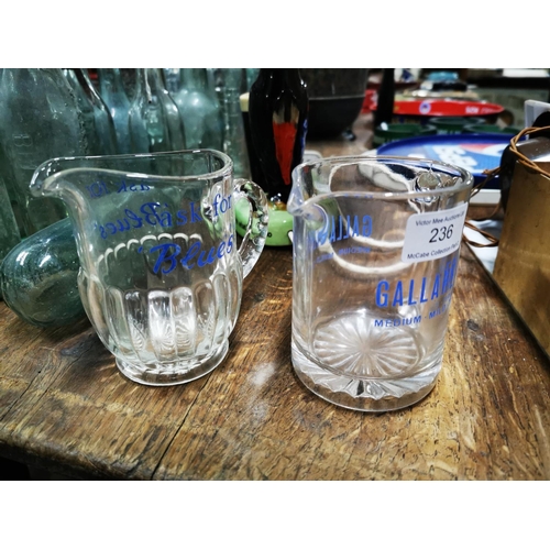 236 - Two Gallagher's glass water jugs.  - Gallagher's Ask For Blue and Gallagher's { Each 12cm H }.