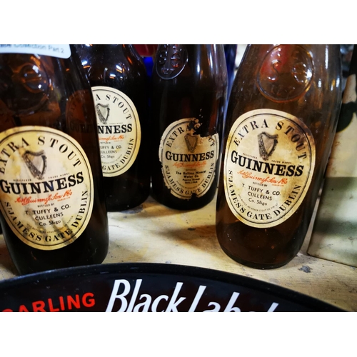 294 - Four Guinness bottles with original labels. - C J Mc Guinness Tubbercurry, Vincent Cooke Castlerea &... 