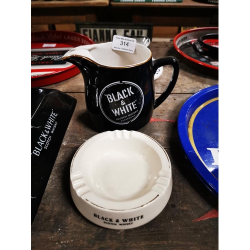 314 - Black and White Scotch Whiskey ceramic water jug and ashtray .