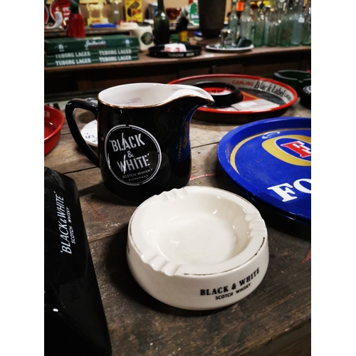 314 - Black and White Scotch Whiskey ceramic water jug and ashtray .