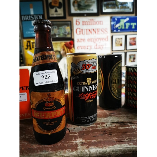 322 - Murphy's Irish Stout bottle and five 1970's Guinness cans.