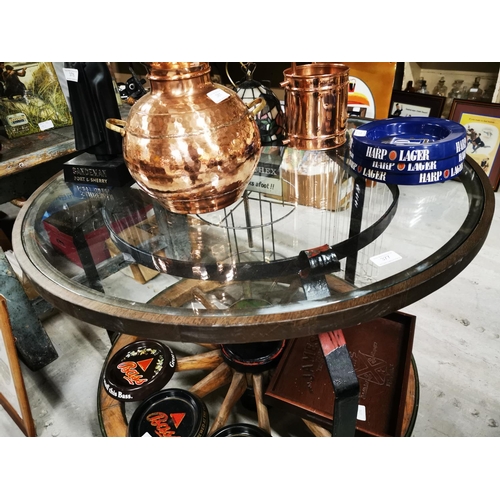 377 - Pub table in the form of wagon wheel with glass top. { 76cm H X 88cm Dia }.