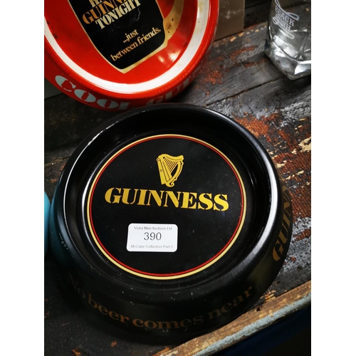 390 - Three Guinness tinplate ashtrays.