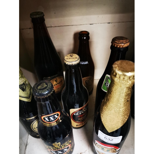 532 - Two shelves of 1980s and 1990s Guinness bottles.