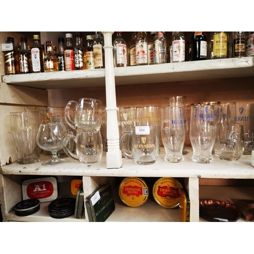 554 - Collection of Guinness pint and half pint glasses and Harp advertising glasses.