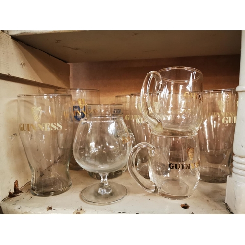 554 - Collection of Guinness pint and half pint glasses and Harp advertising glasses.