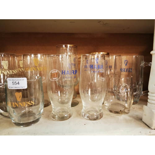 554 - Collection of Guinness pint and half pint glasses and Harp advertising glasses.