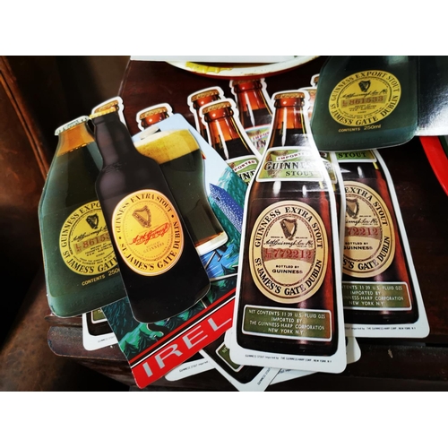 629 - Collection of Guinness memorabilia - postcards, toucan and bottles.