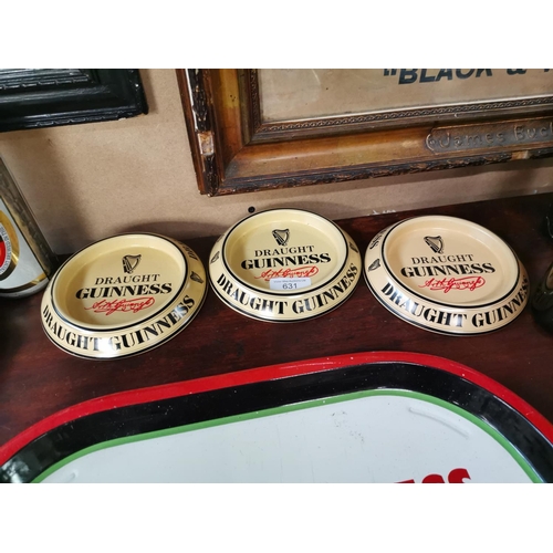 631 - Three Guinness tin plate ashtrays.