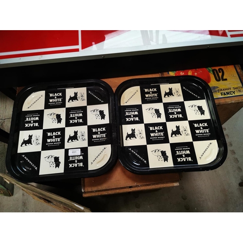 651 - Two Black and White tinplate advertising trays {35 cm H x 35 cm W}.