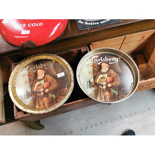 657 - Two Carlsberg tinplate advertising drinks' trays. { 30cm Dia & 33cm Dia. }.