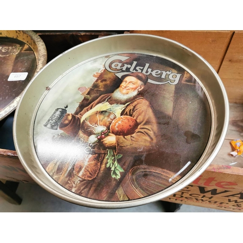 657 - Two Carlsberg tinplate advertising drinks' trays. { 30cm Dia & 33cm Dia. }.