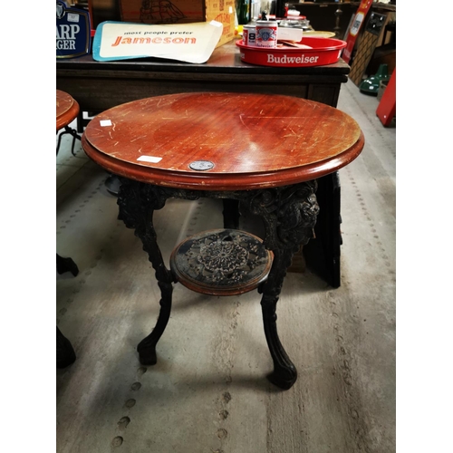 710 - Cast iron and mahogany top pub table {69 cm H x 59 cm Dia.}.