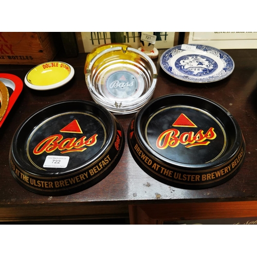 722 - Two Bass tinplate ashtrays and one Bass glass advertising ashtray.