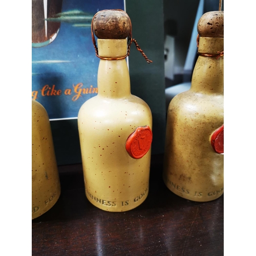 729 - Four Guinness Is Good For You Carleton ware ceramic bottles {17 cm H}.