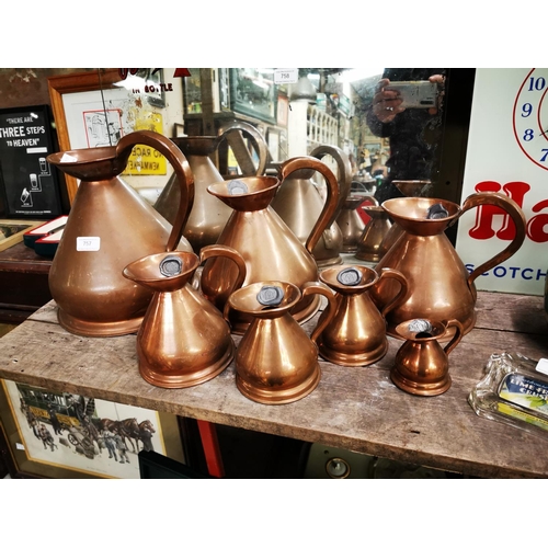 757 - Set of seven copper measures. {28 cm H}.