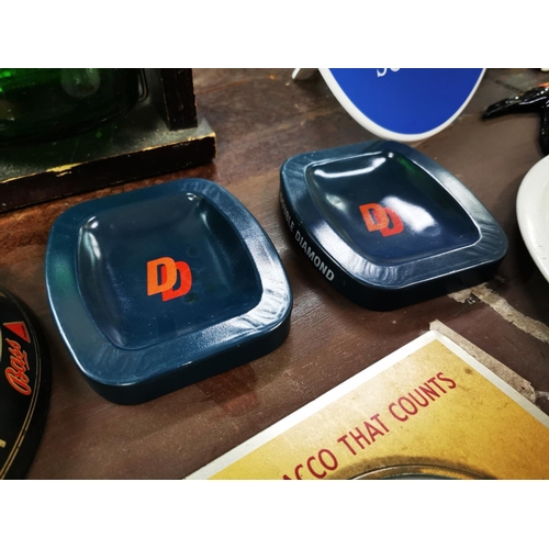 831 - Two tin plate Bass ashtrays and two Double Diamond ashtrays.