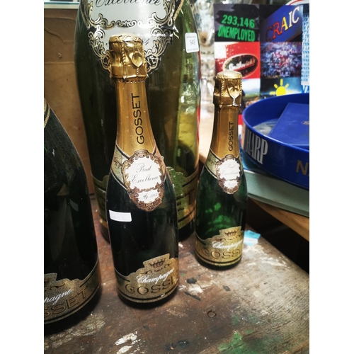 949 - Set of six graduating Gosset display champagne bottles {Largest 63 cm H and Smallest 17cm H}.