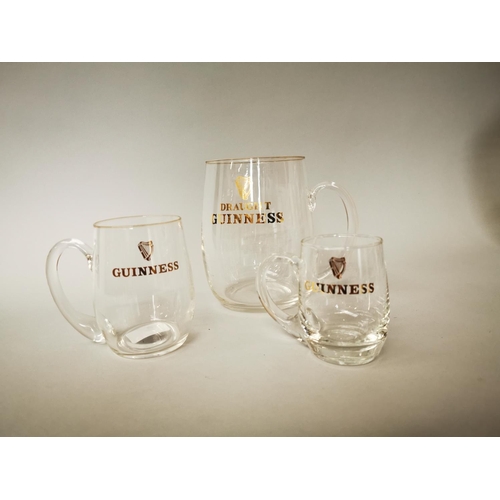 30 - Set of three 1950s Guinness glass advertising tankards {18 cm H, 12 cm H and 10 cm H}.