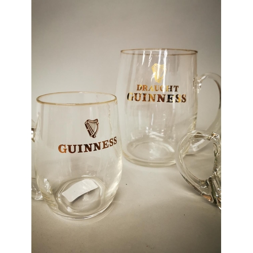 30 - Set of three 1950s Guinness glass advertising tankards {18 cm H, 12 cm H and 10 cm H}.