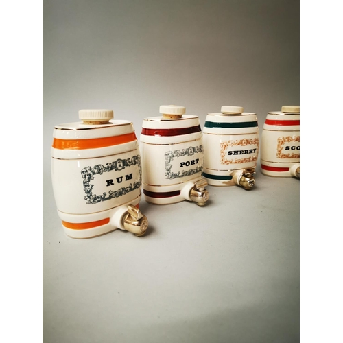 50 - Set of six miniature ceramic drinks dispensers {12 cm H x 10 cm W x 10 cm D}.