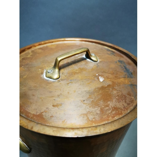 159 - Good quality hand beaten copper lidded stock pot with brass handles {29 cm H x 39 cm W x 29 cm D}.