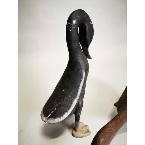 17 - Pair of decorative hand painted metal ducks {38 cm H and 24 cm H}.