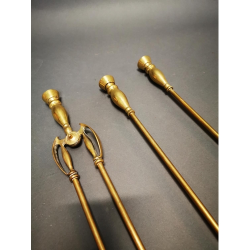 171 - Set of three Victorian brass fire irons {70 cm H}.