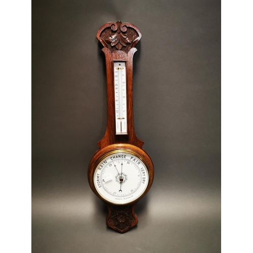236 - Edwardian carved oak barometer with enamel dial {80 cm H x 26 cm W}.