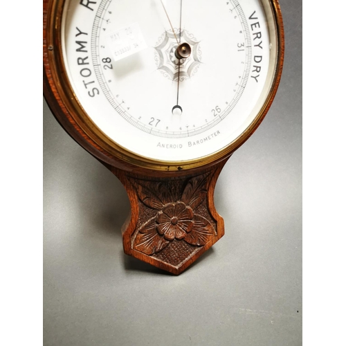 236 - Edwardian carved oak barometer with enamel dial {80 cm H x 26 cm W}.