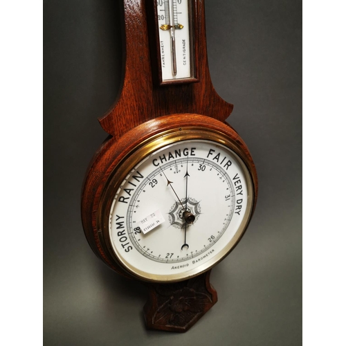 236 - Edwardian carved oak barometer with enamel dial {80 cm H x 26 cm W}.