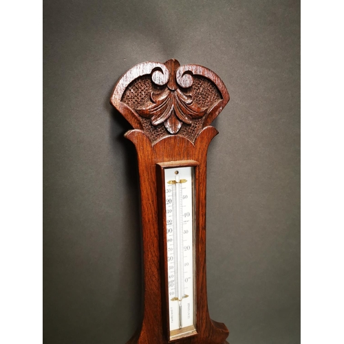 236 - Edwardian carved oak barometer with enamel dial {80 cm H x 26 cm W}.
