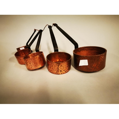 248 - Set of five graduated hand beaten copper saucepans.