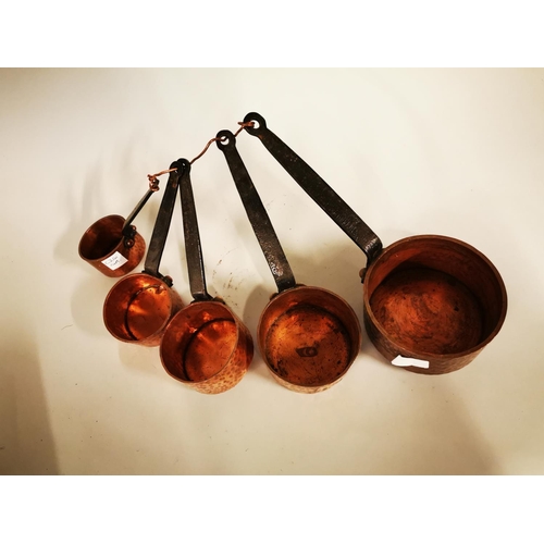 248 - Set of five graduated hand beaten copper saucepans.