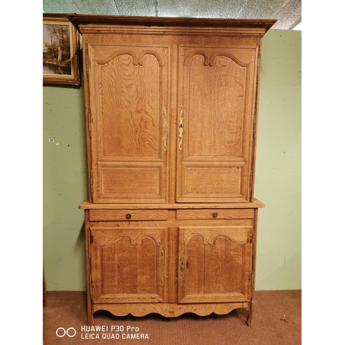 255 - Early 19th C. bleached oak two piece kitchen cupboard two long panelled doors over two short drawers... 