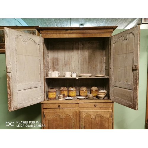 255 - Early 19th C. bleached oak two piece kitchen cupboard two long panelled doors over two short drawers... 