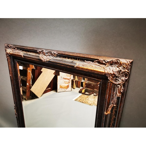 256 - Decorative gilt wall mirror {112 cm H x 81 cm W}.