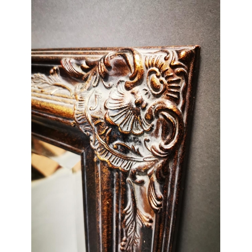 256 - Decorative gilt wall mirror {112 cm H x 81 cm W}.