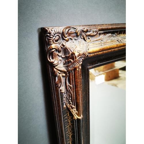256 - Decorative gilt wall mirror {112 cm H x 81 cm W}.