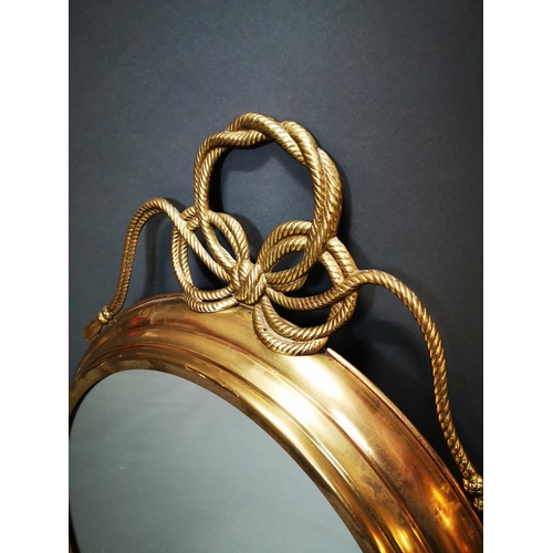 268 - Good quality brass framed wall mirror decorated with swags in the Regency style {80 cm H x 62 cm W}.