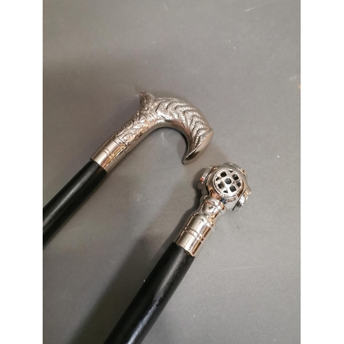 297 - Two silver plated top walking sticks {96 cm H}.