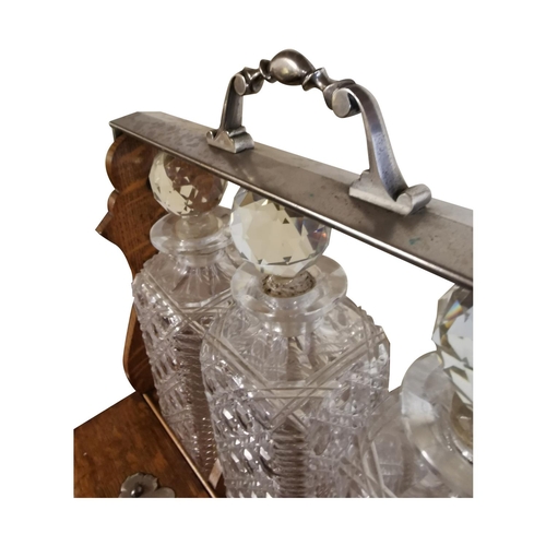 311 - Good quality 19th C. oak tantulus with three complete glass decanters {42 cm H x 33 cm W x 26 cm D}.