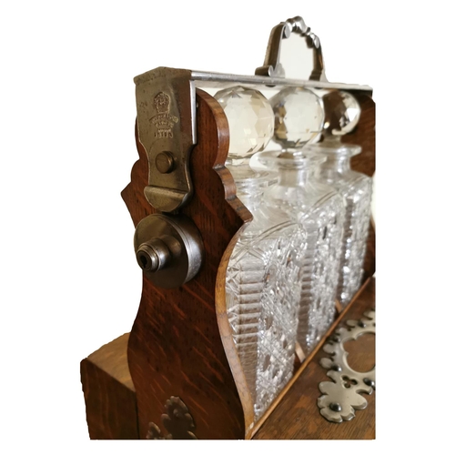311 - Good quality 19th C. oak tantulus with three complete glass decanters {42 cm H x 33 cm W x 26 cm D}.