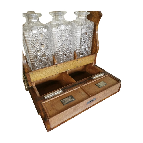 311 - Good quality 19th C. oak tantulus with three complete glass decanters {42 cm H x 33 cm W x 26 cm D}.