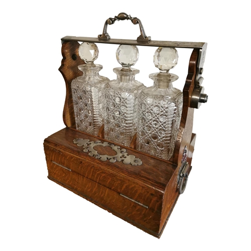 311 - Good quality 19th C. oak tantulus with three complete glass decanters {42 cm H x 33 cm W x 26 cm D}.