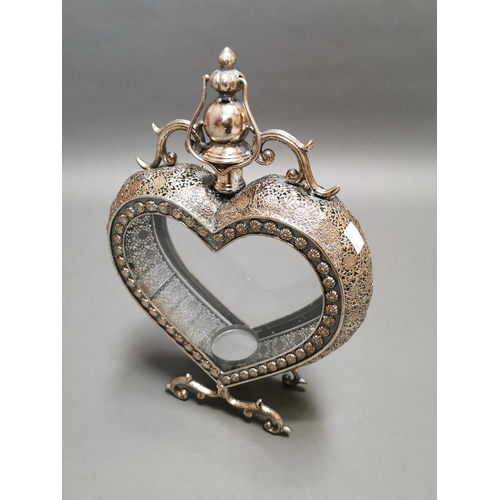 314 - Decorative silver plated candle holder in the form of a heart {52 cm H x 38 cm W x 11 cm D}.