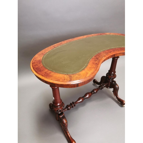 315 - 19th C. walnut and mahogany kidney shaped desk with inset leather top on carved supports and single ... 